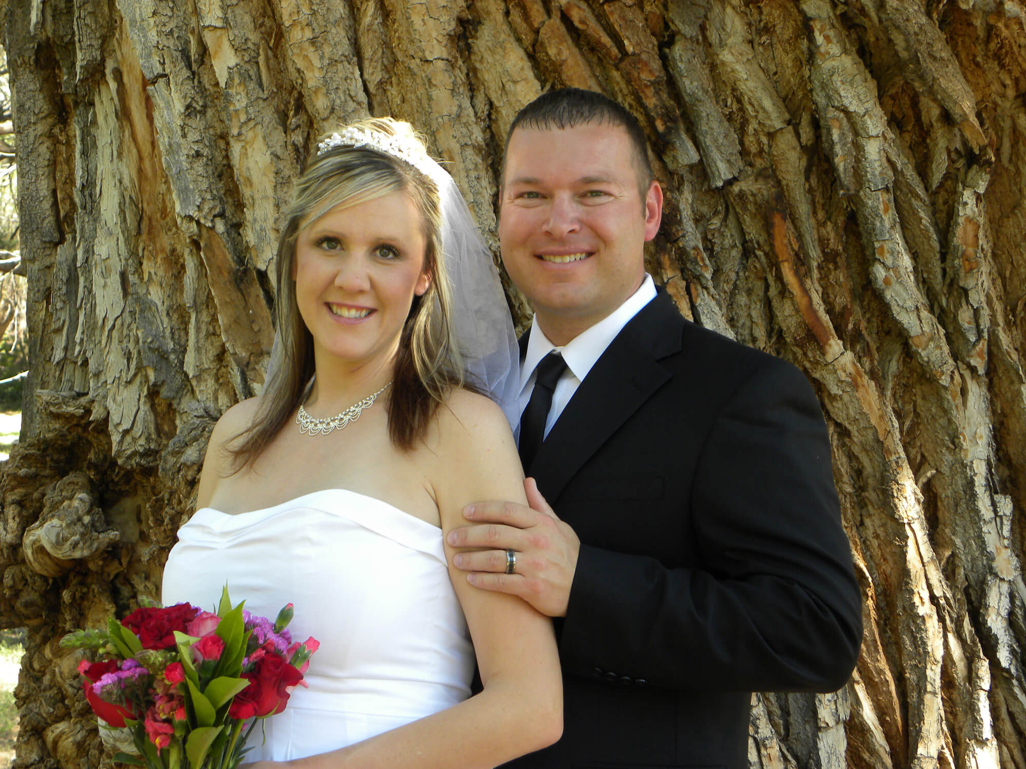 Newly married couple in front of the Wedding Tree in Sedona